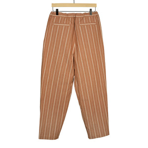 Pleated drawstring trousers in burnt orange and white striped cotton/linen